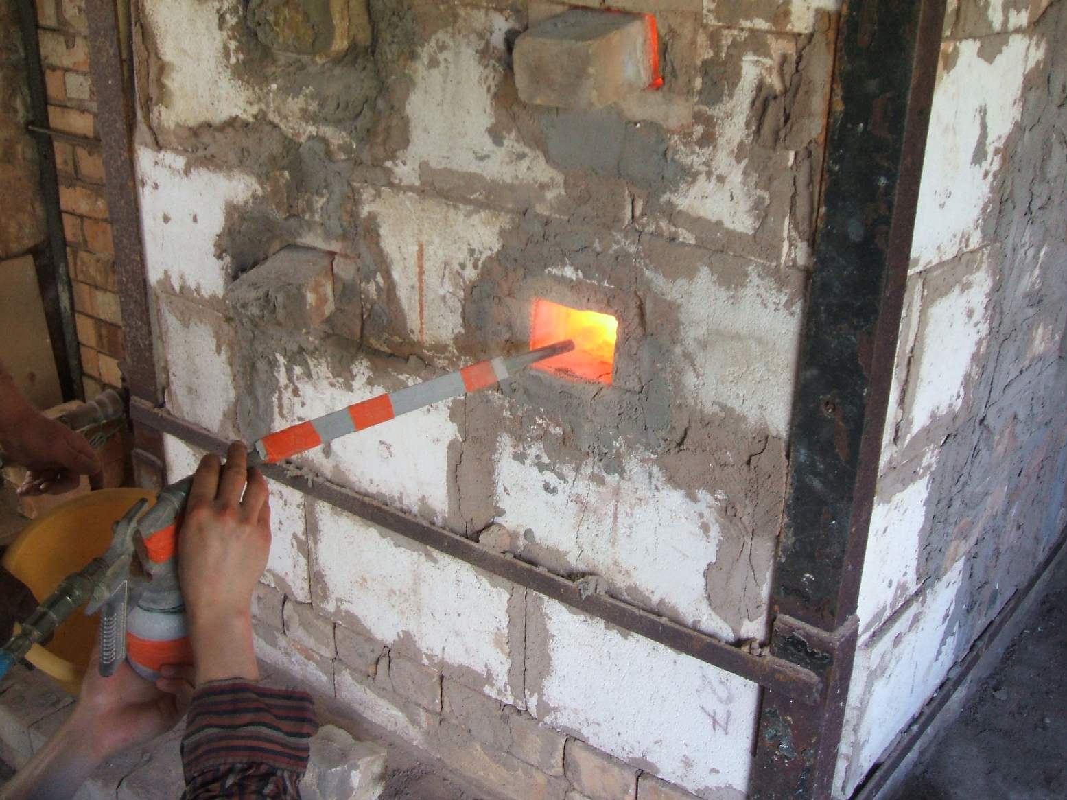 wood ash being blown into the kiln